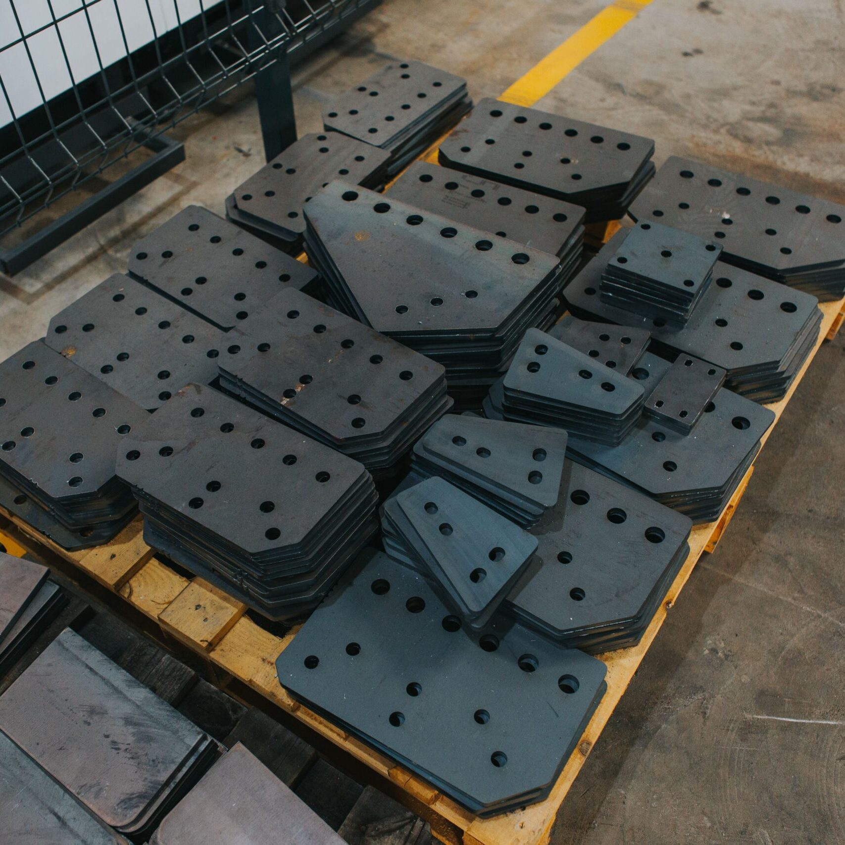 A bunch of different kinds of connecting plates stacked in neat piles